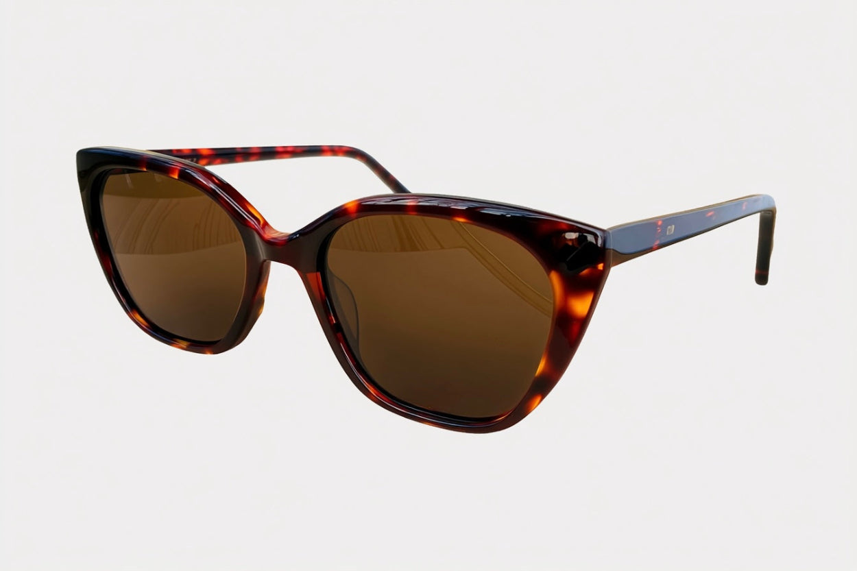 Sunglasses with tortoiseshell frame and brown lenses on a light gray background